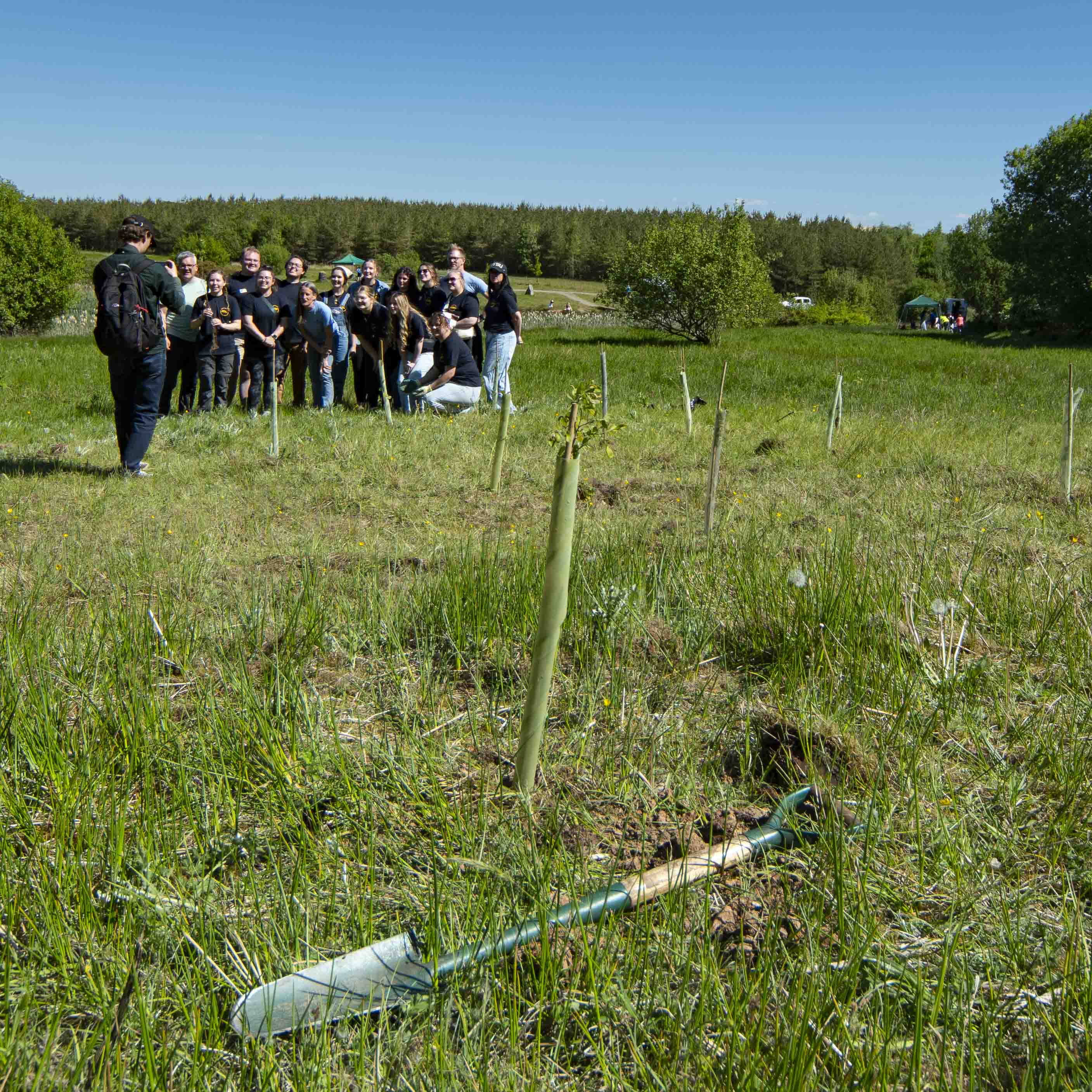 Taylor photographing a group of student teachers from the USA helping plant trees for the Wildwood project at Hannahston. A former open cast mine, now owned by the local community.