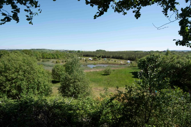 The former open cast mine at Hannahston. Now a community owned woodland. The tents and vehicles are stalls and information posts for the 4th annual open day.